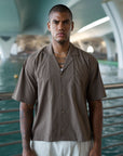 Model wearing the brown Casa Shirt, cropped boxy fit