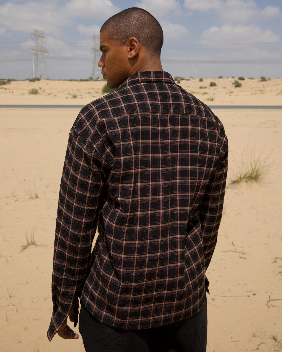 Brown marble resin button detail on the seersucker shirt
