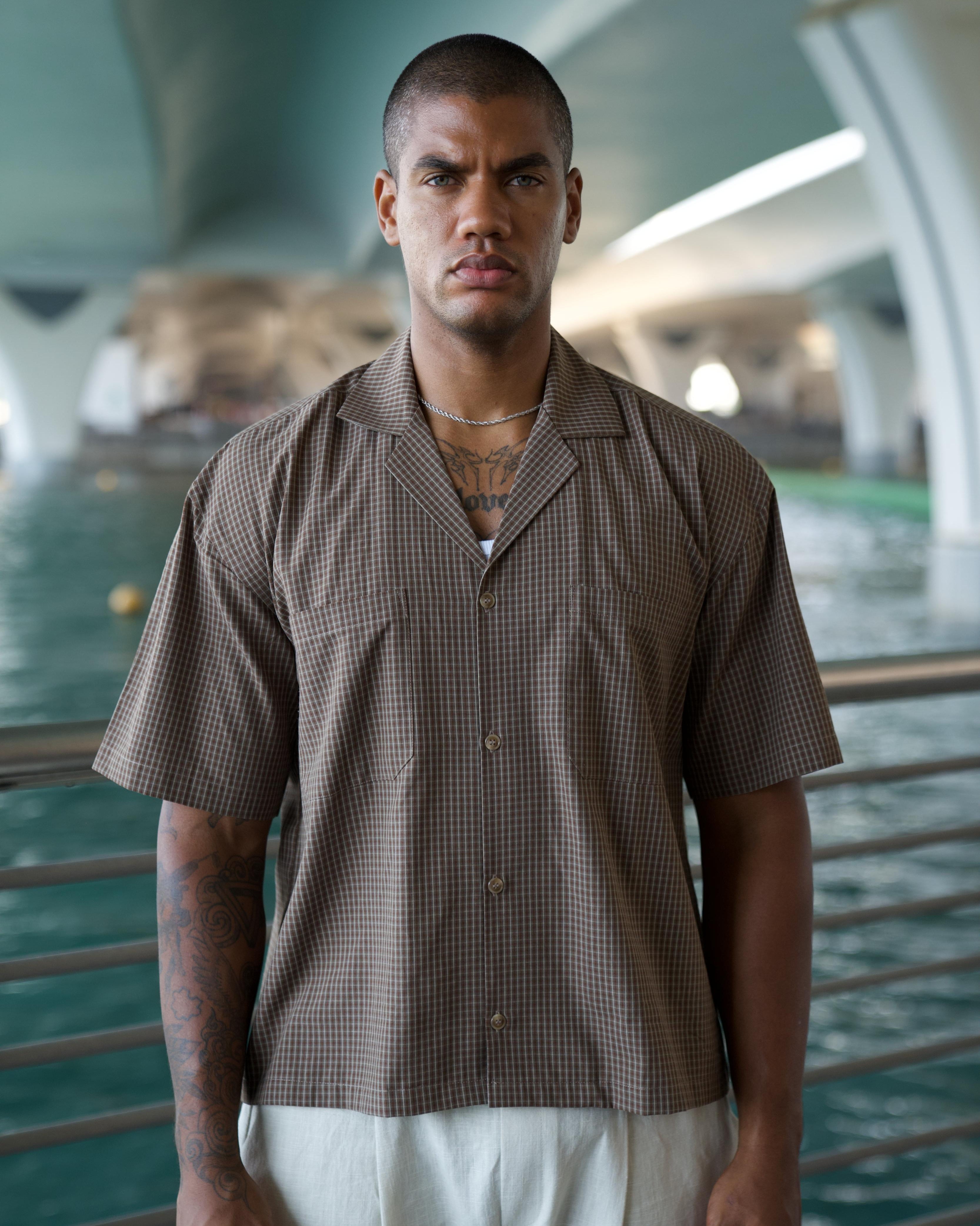 Model wearing the brown Cuban Check Shirt, cropped boxy fit