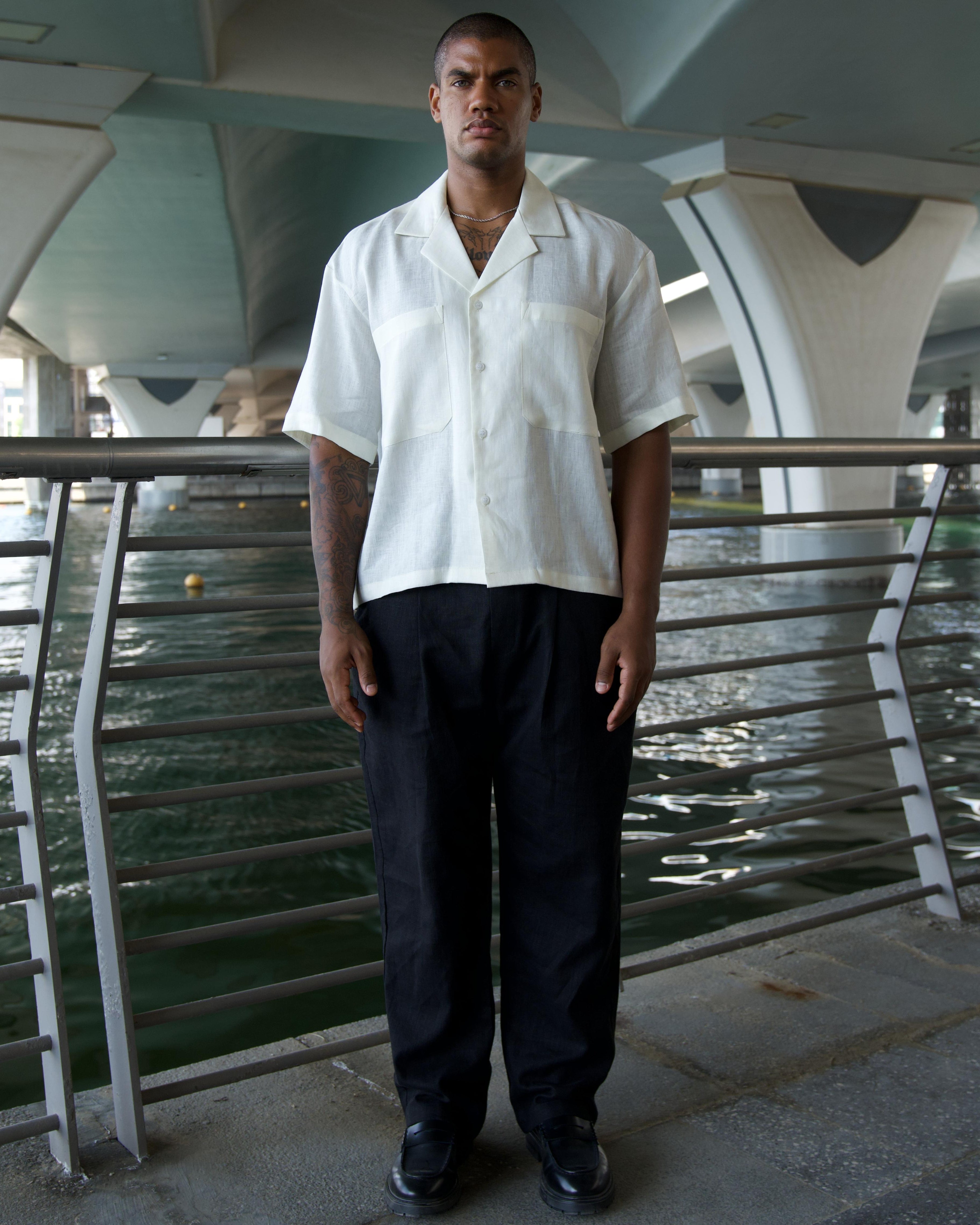 Off-white linen shirt showing double breast pockets and white resin buttons