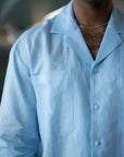 Linen fabric and white resin button detail in pale blue