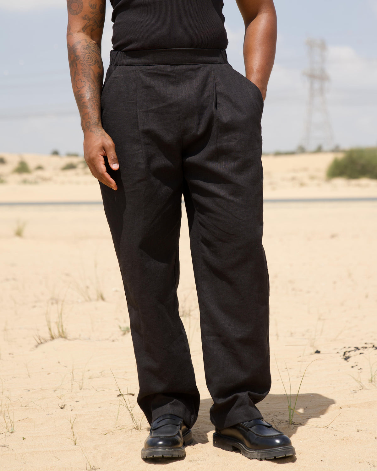 Model wearing the black Pleated Pants, full length
