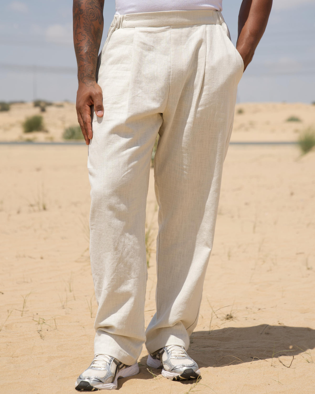 Model wearing the cream Pleated Pants, full length