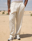 Model wearing the cream Pleated Pants, full length
