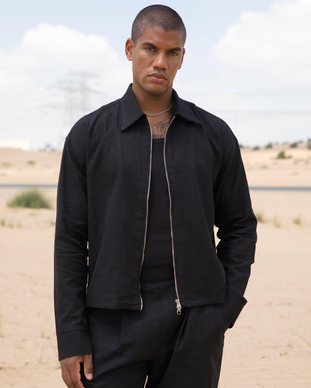 Model wearing the black Zip Overshirt, cropped fit